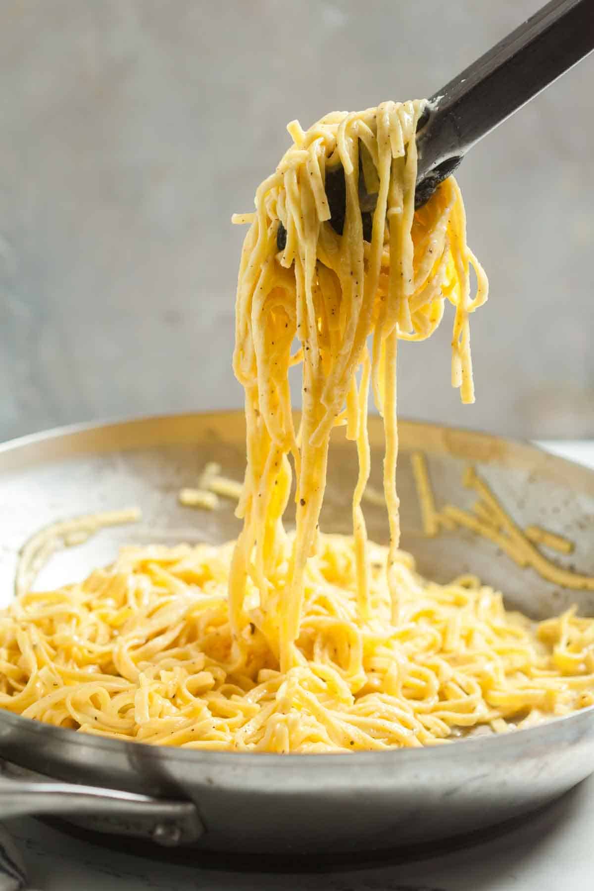 Tons lifting this easy cacio e pepe recipe from the pot.