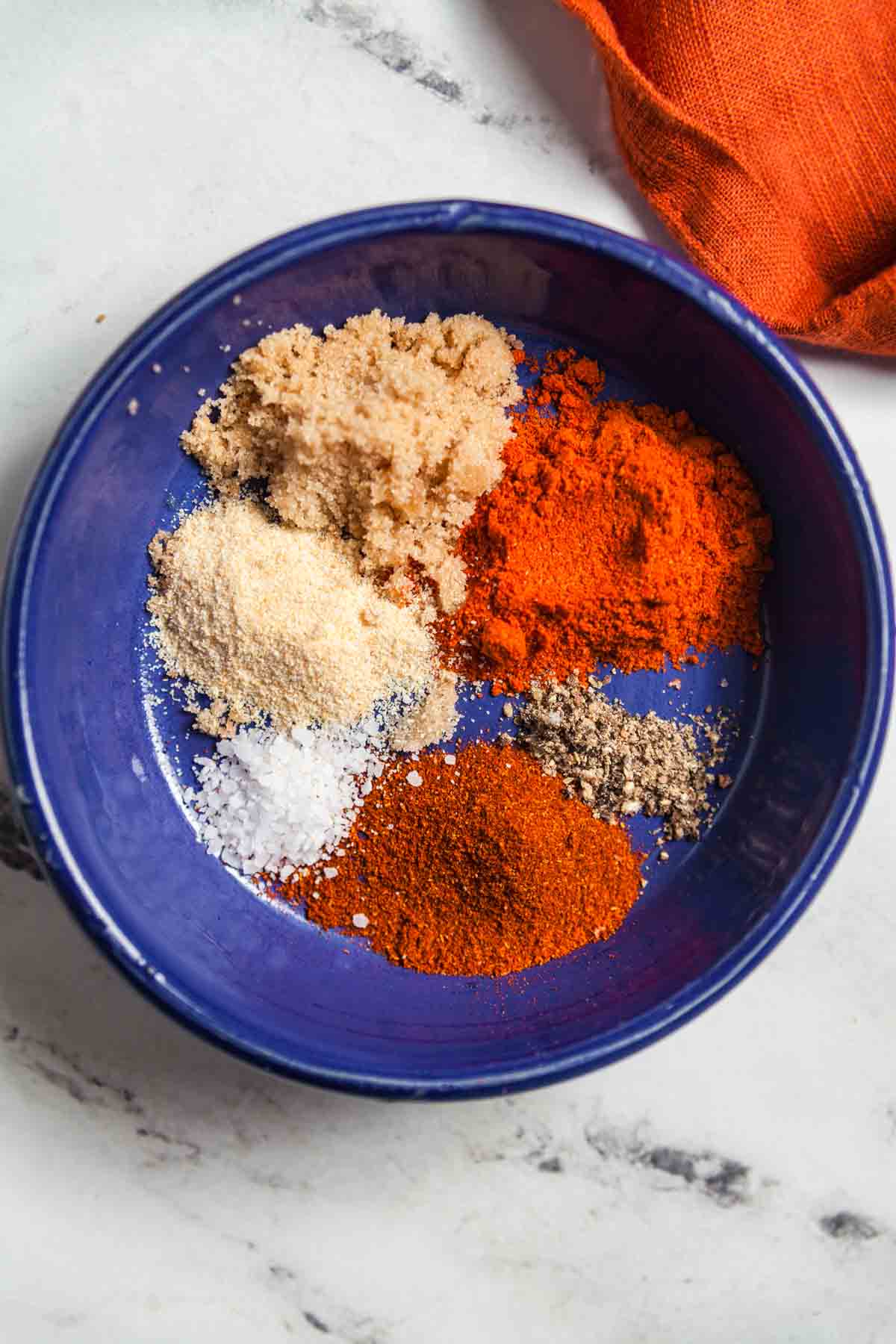 Mixing up your own homemade Nashville hot chicken sauce is easy with spices, brown sugar, and oil. 