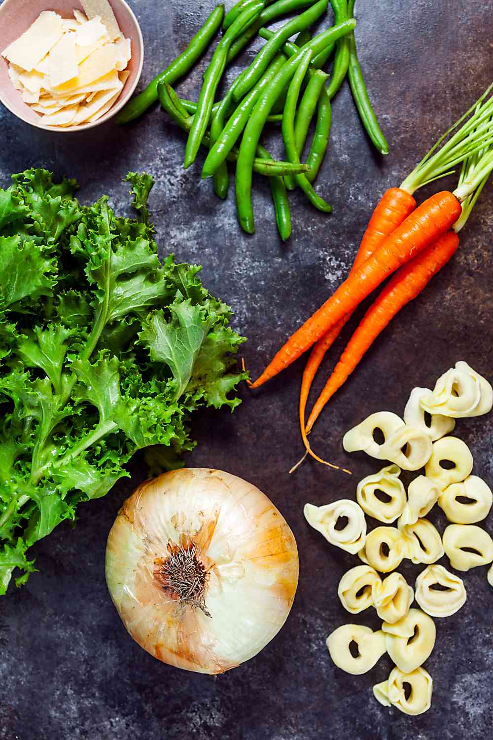 Ingredients for making vegetable soup with tortellini.  