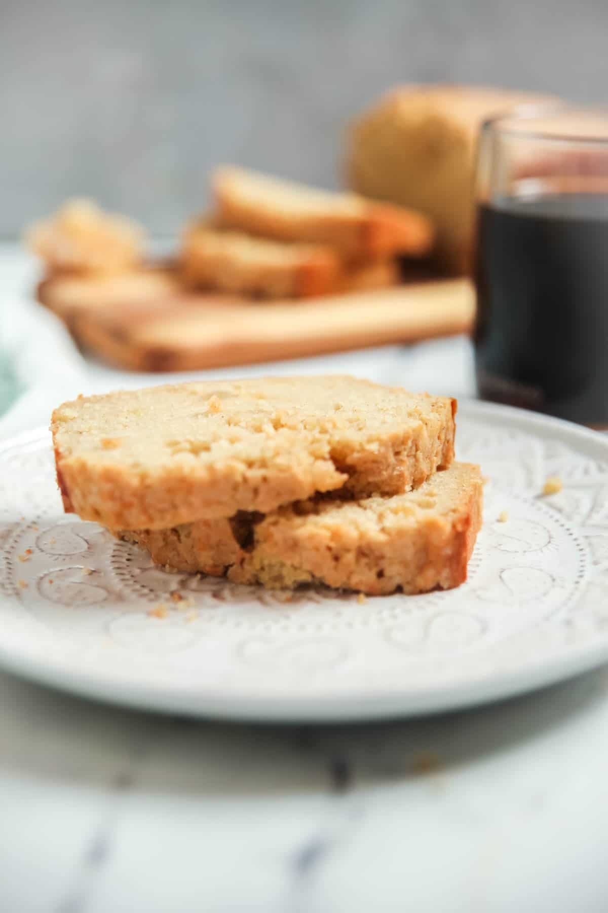 Two slices of applesauce quick bread on a white plate. 