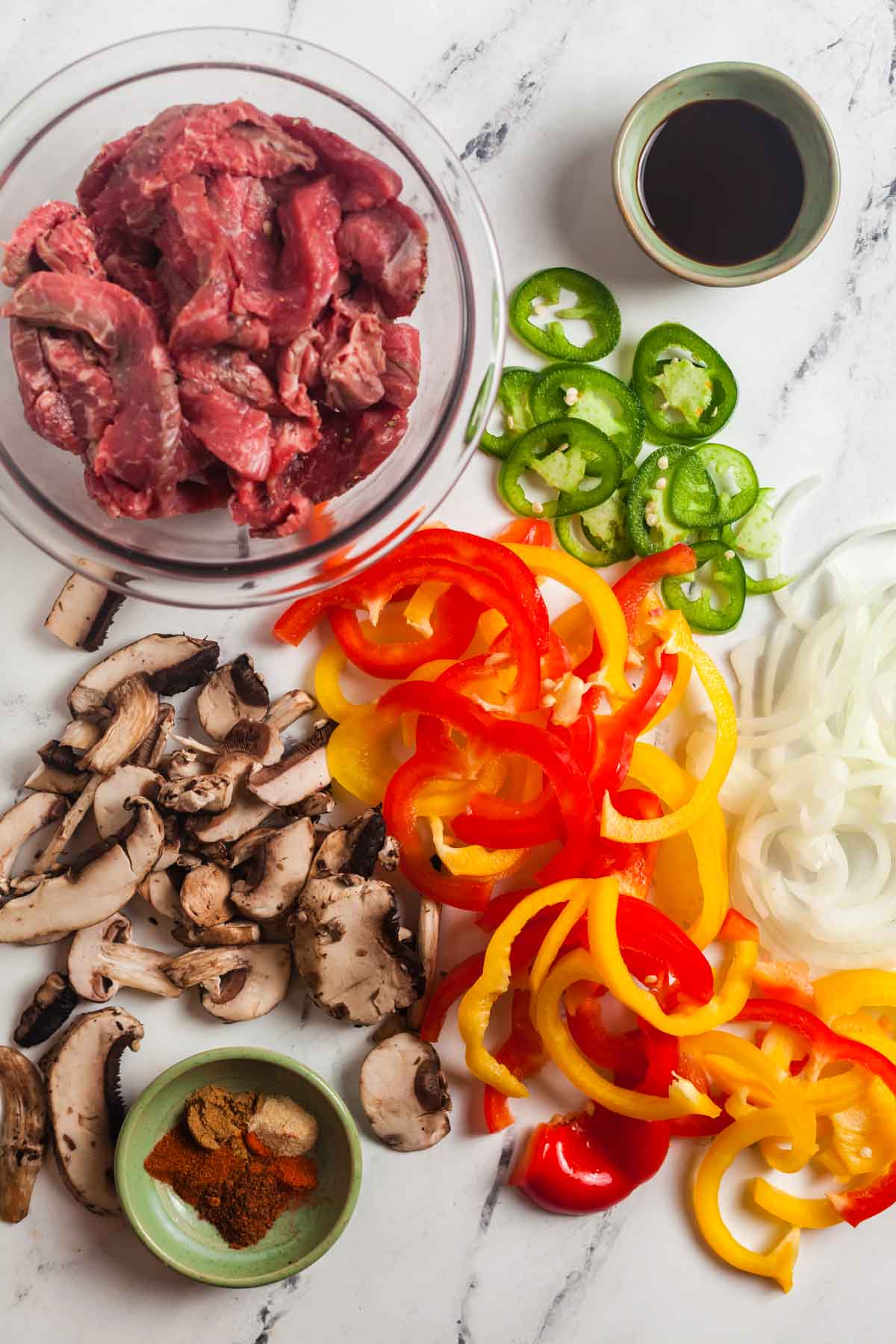 Overhead view of ingredients needed to make baked sheet pan fajitas.
