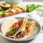 two steak fajitas on a plate