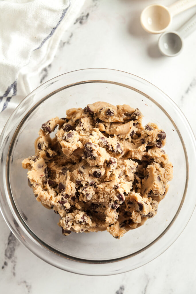Overhead view of a bowl of chocolate chip cookie dough. 