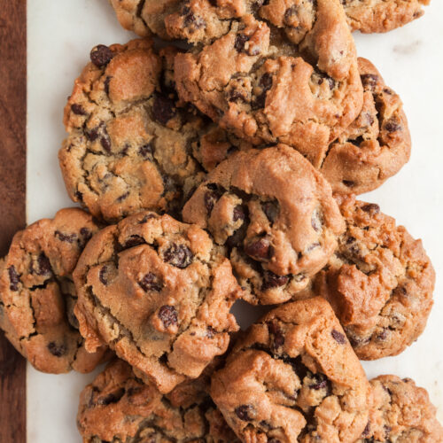 Air fried chocolate chip cookies on a white marble board.