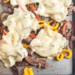 Melting the cheese on top of the Sheet pan cheesesteak filling