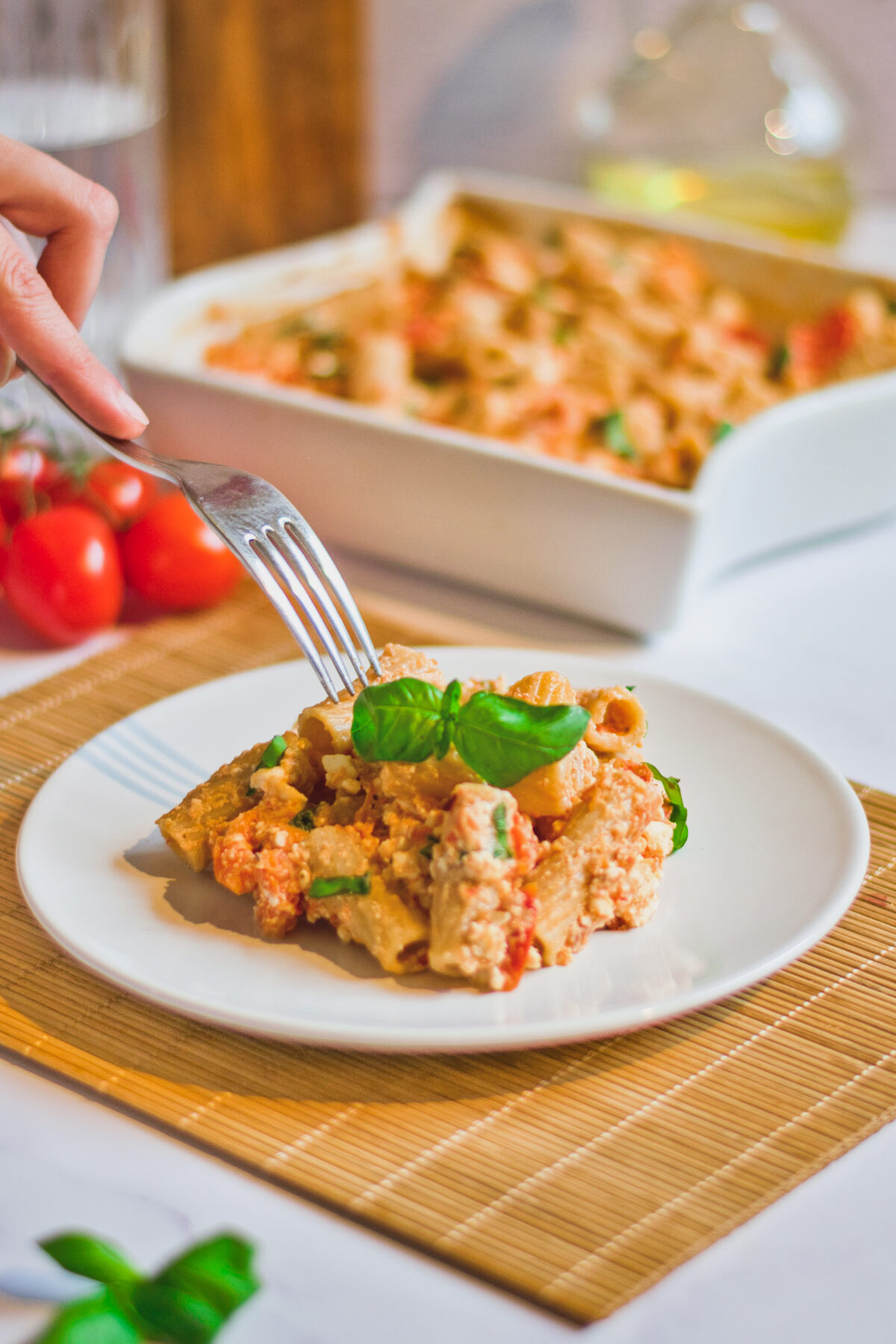 eating a portion of baked feta pasta. 
