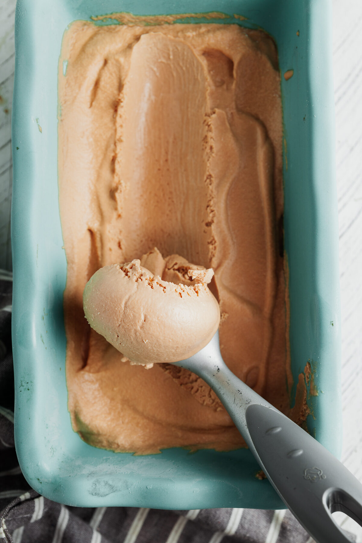 Scooping a serving of homemade coffee ice cream. 