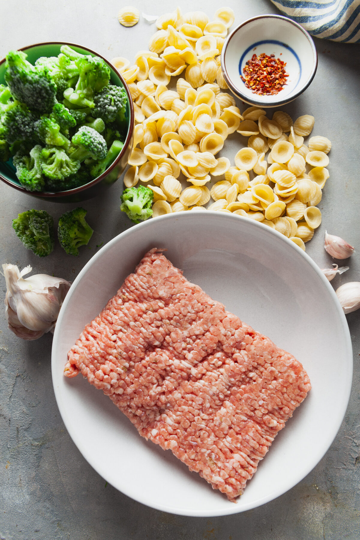 Ingredients to make orecchiette with broccoli and sausage.