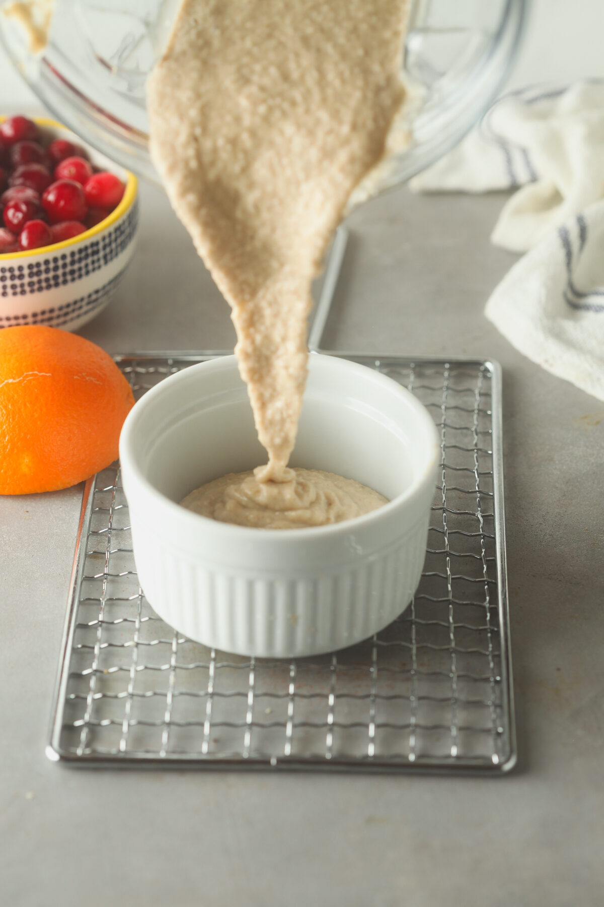 Pouring the oat mixture into a ramekin. 