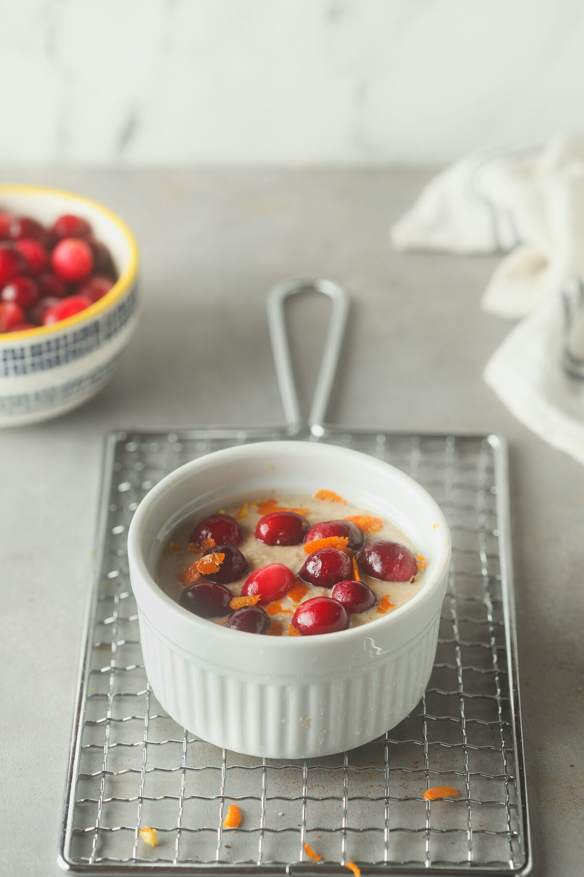 Topping the batter with cranberries.
