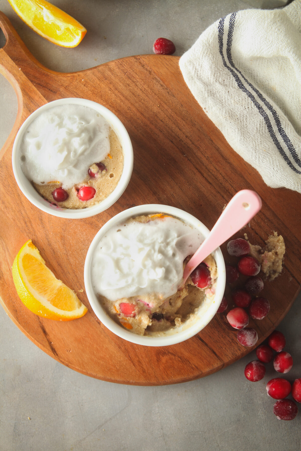 Overhead view of two ramekins with cranberry baked oats. 