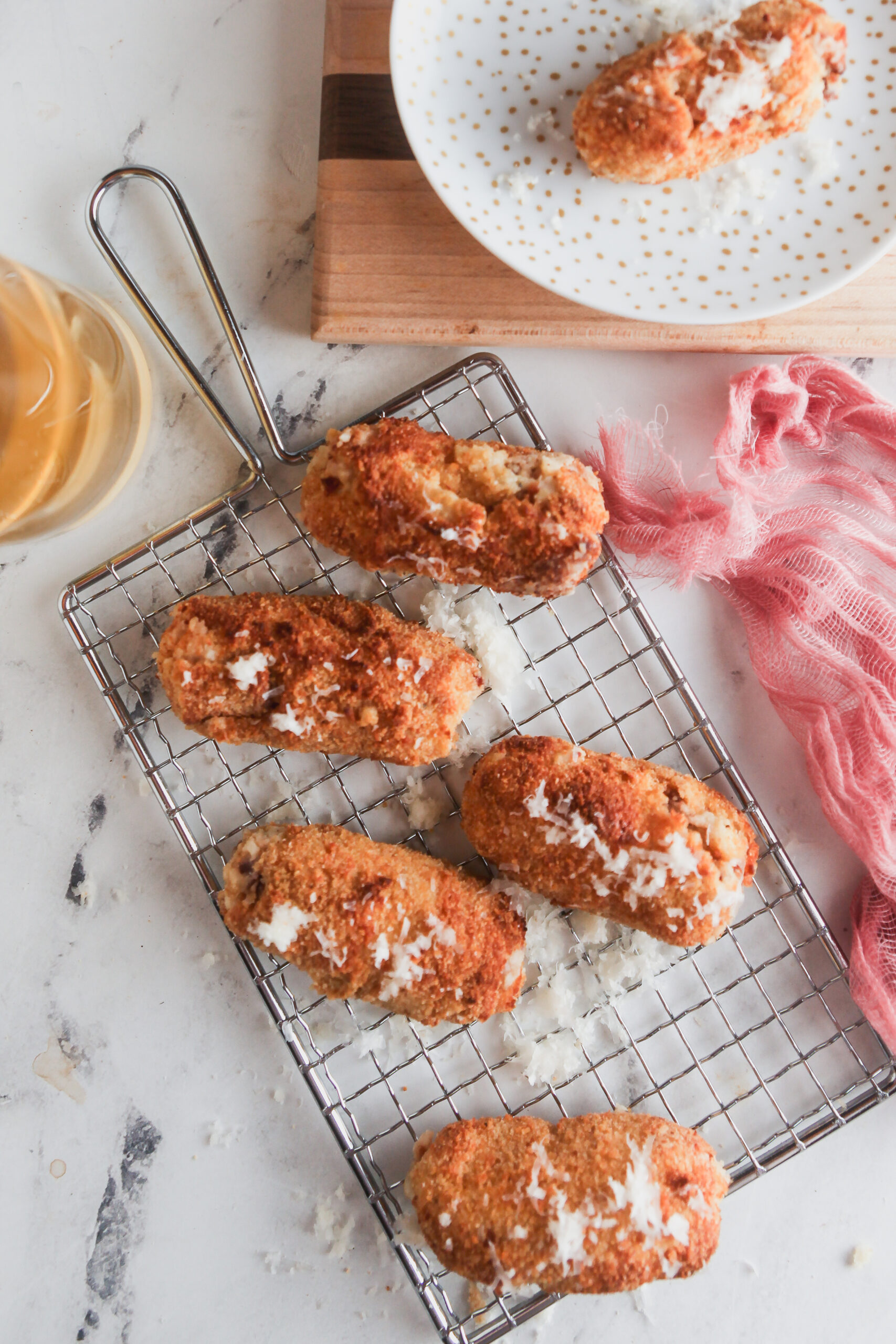 Overhead image of air fryer croquettes on a marble background.