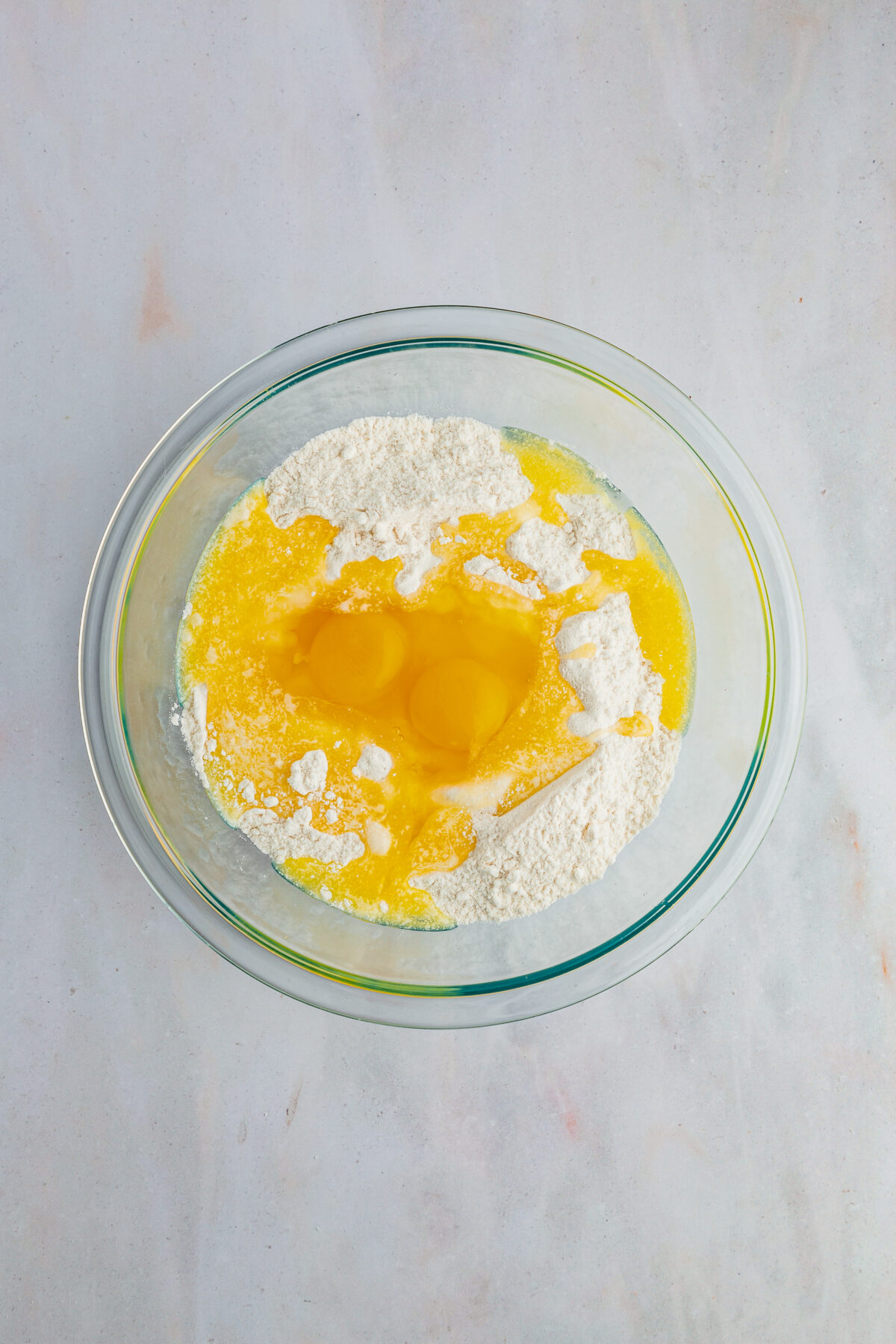 Mixing in the melted butter and eggs. 