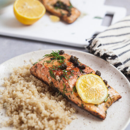 Salmon meuniere on a white plate.