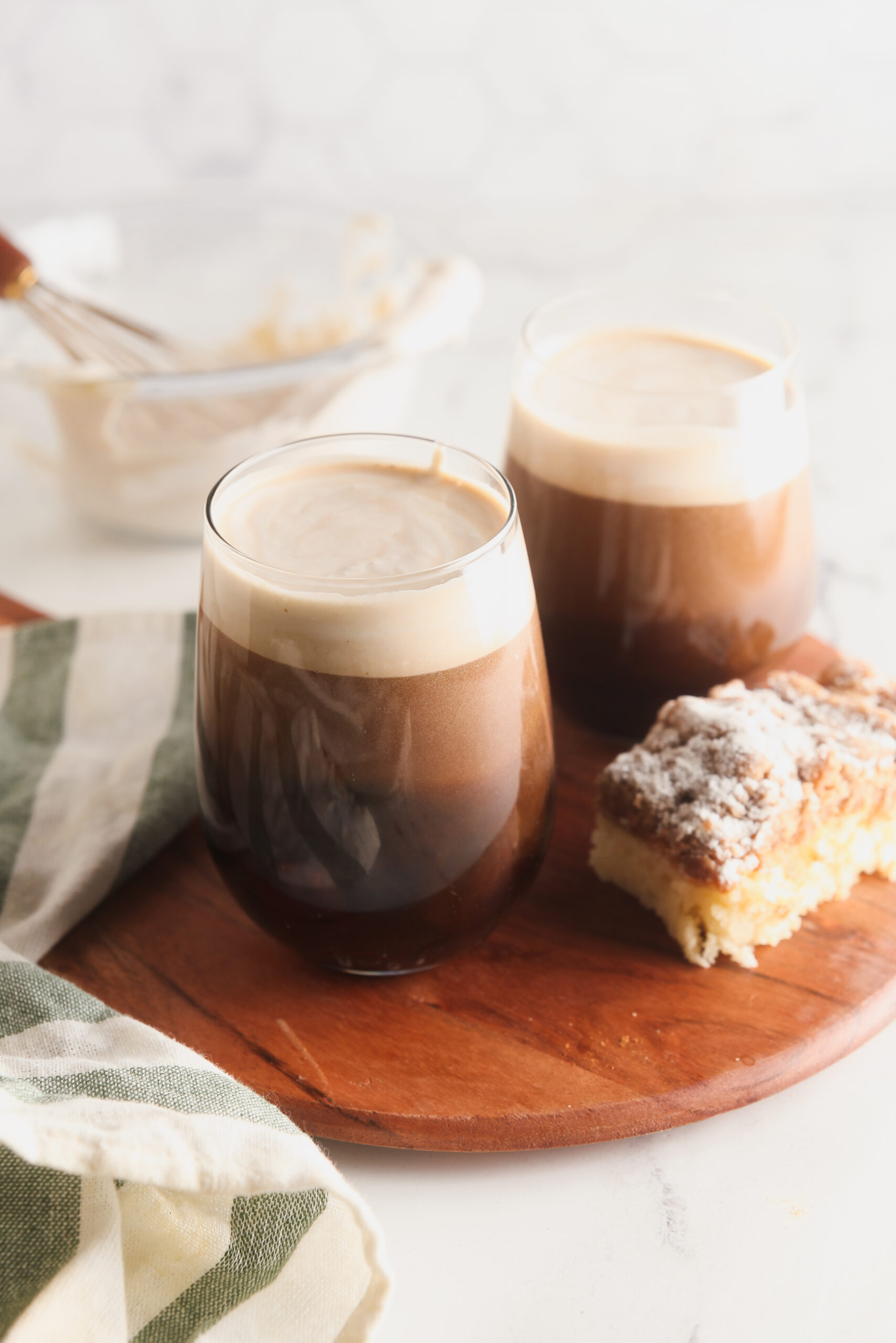 Two glasses of cold brew coffee topped with homemade vanilla sweet cream cold brew.