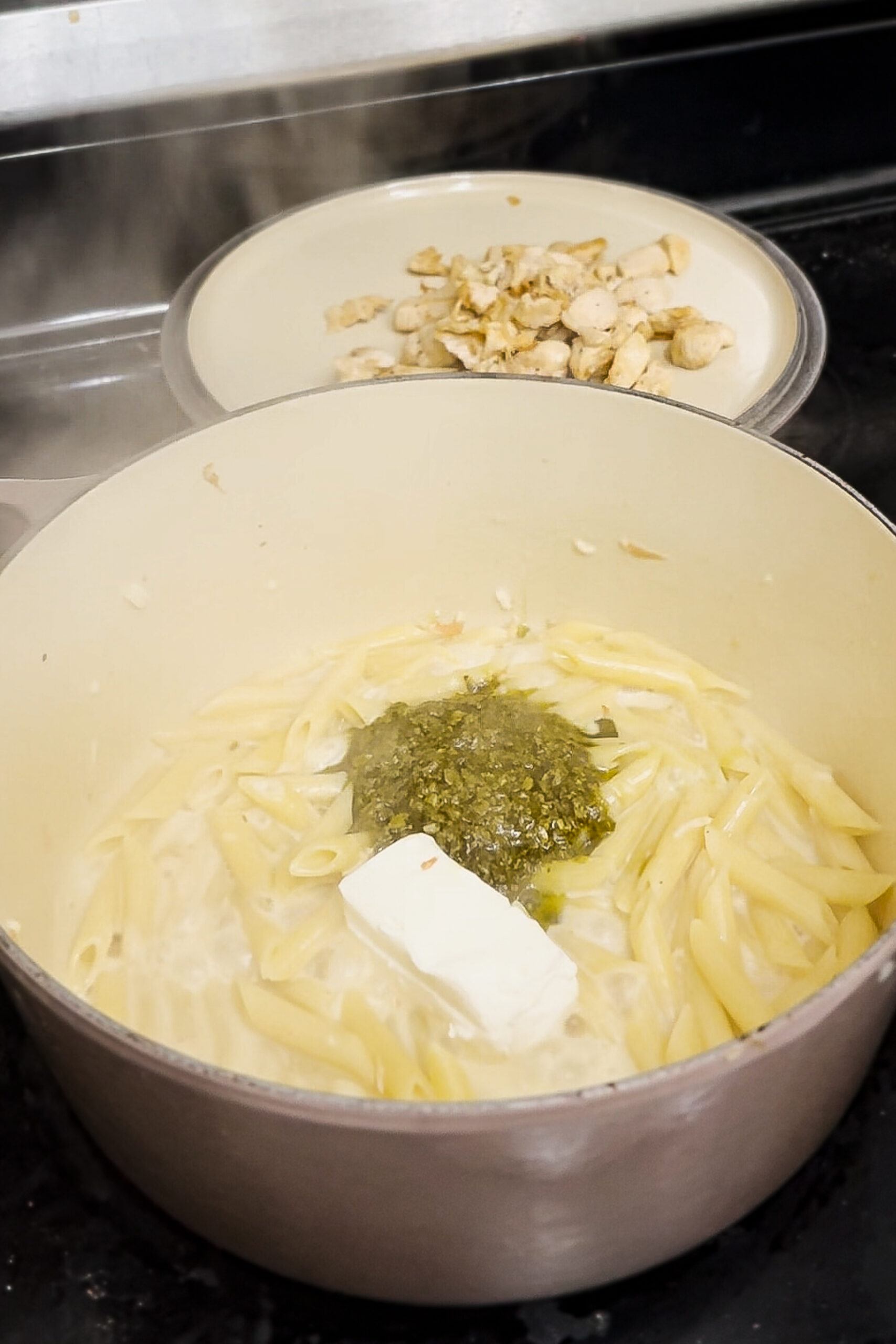 Adding pesto and cream cheese. 