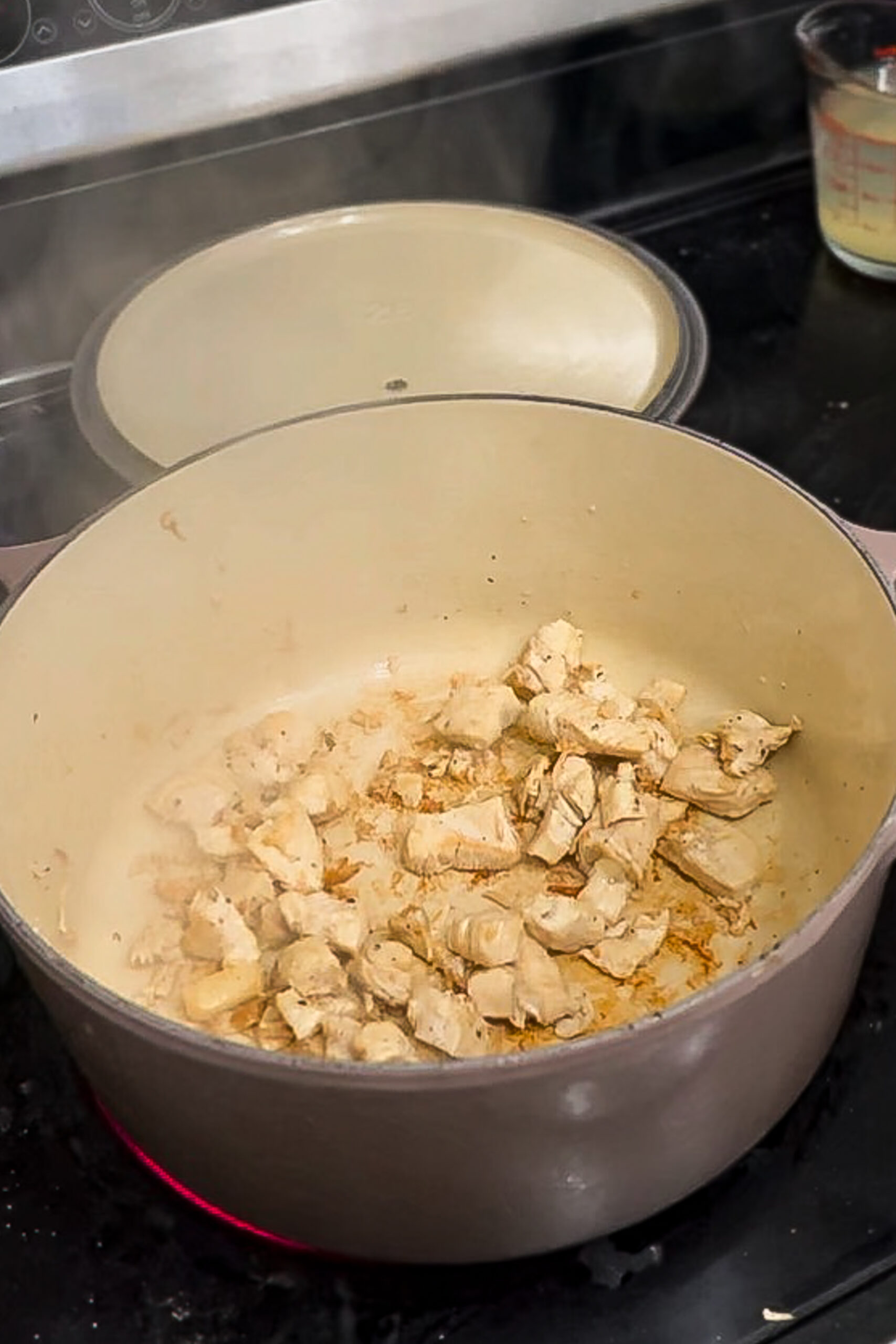 Sauteeing chicken in a large pot. 