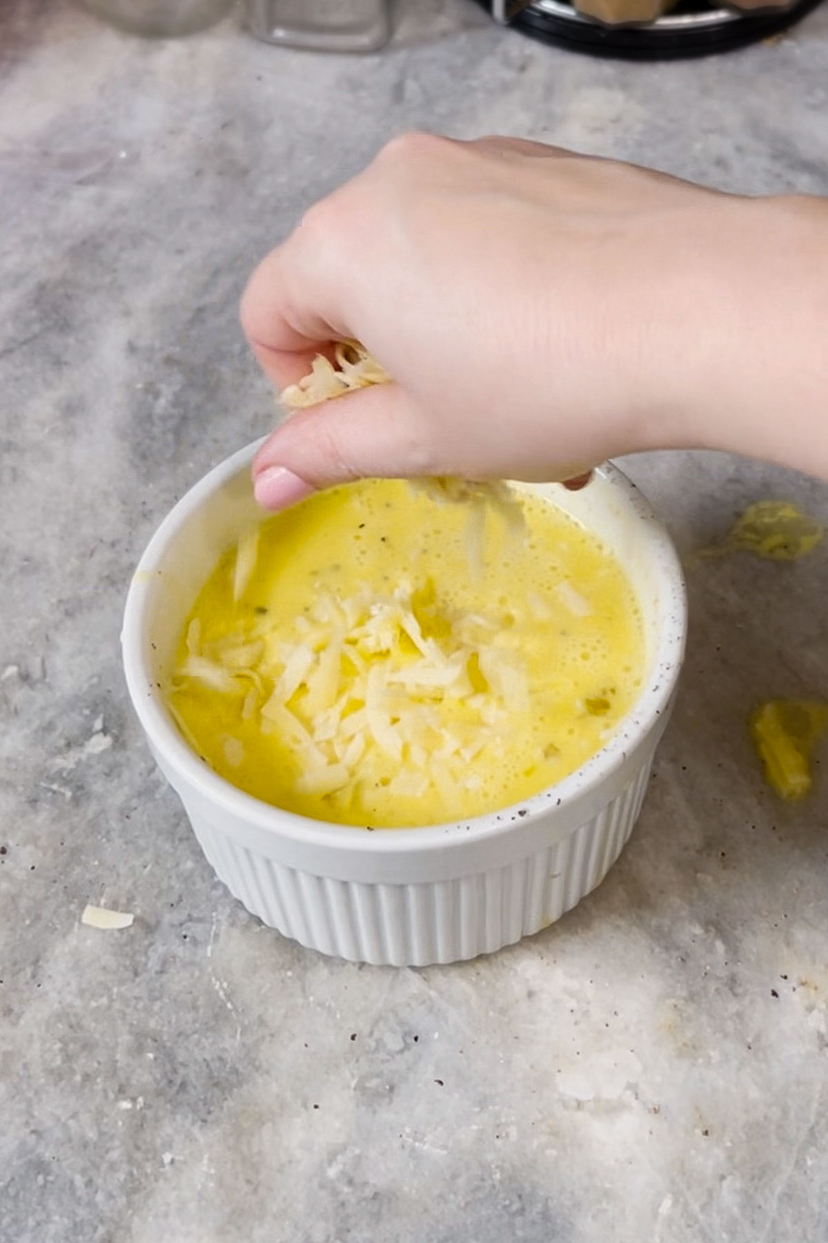 Adding shredded cheese. 