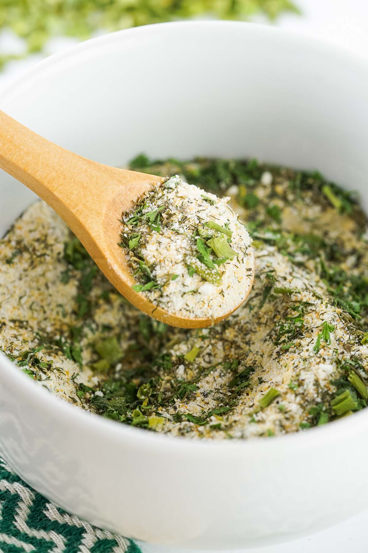 A white bowl filled with homemade ranch seasoning mix. 