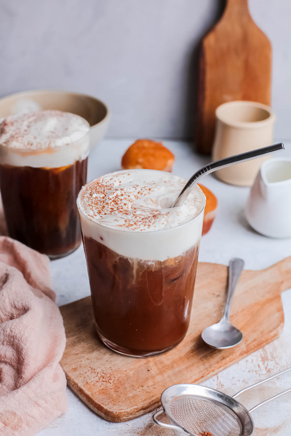 Two glasses of Irish cream cold brew coffee with a straw. 