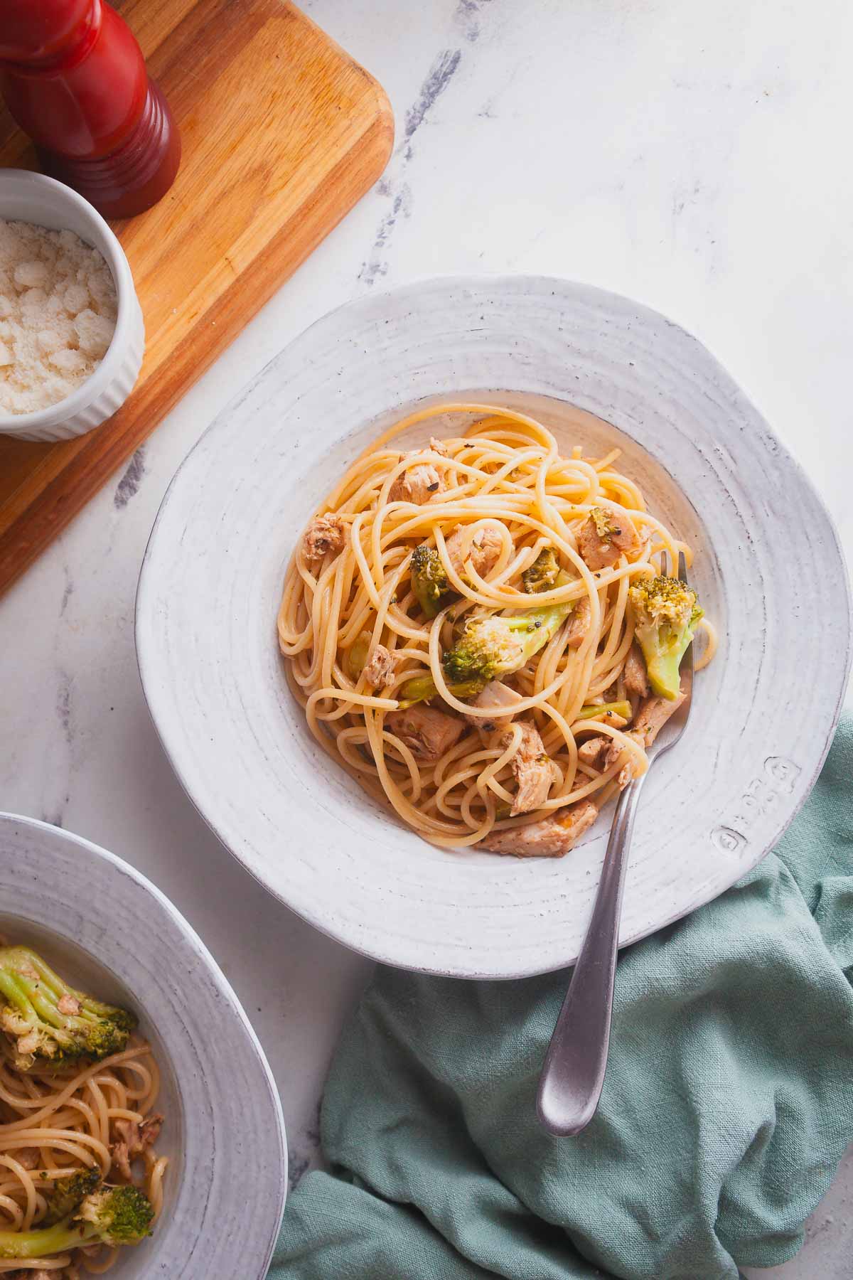 A dish of lemon chicken pasta on a marble countertop. 