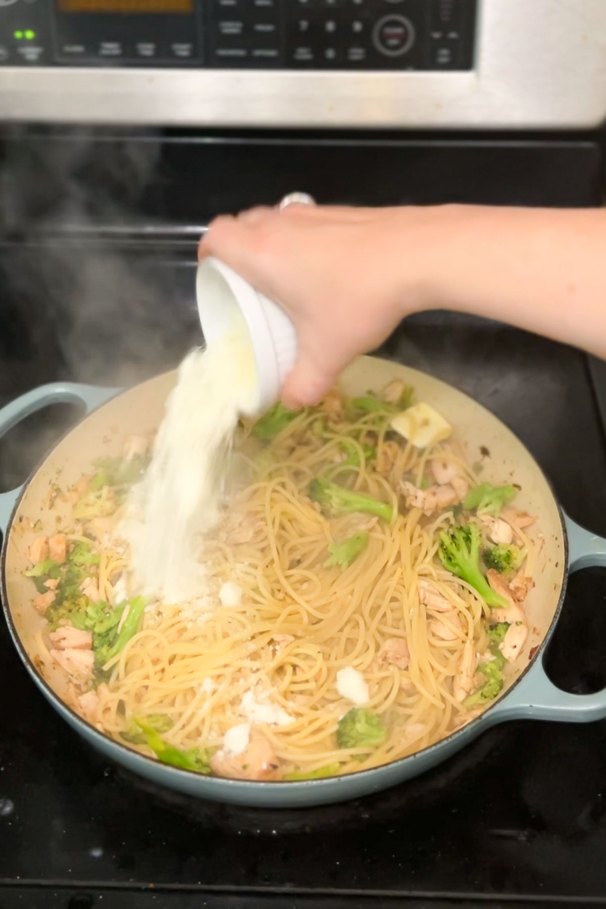 Finishing the lemon pasta off with grated cheese. 