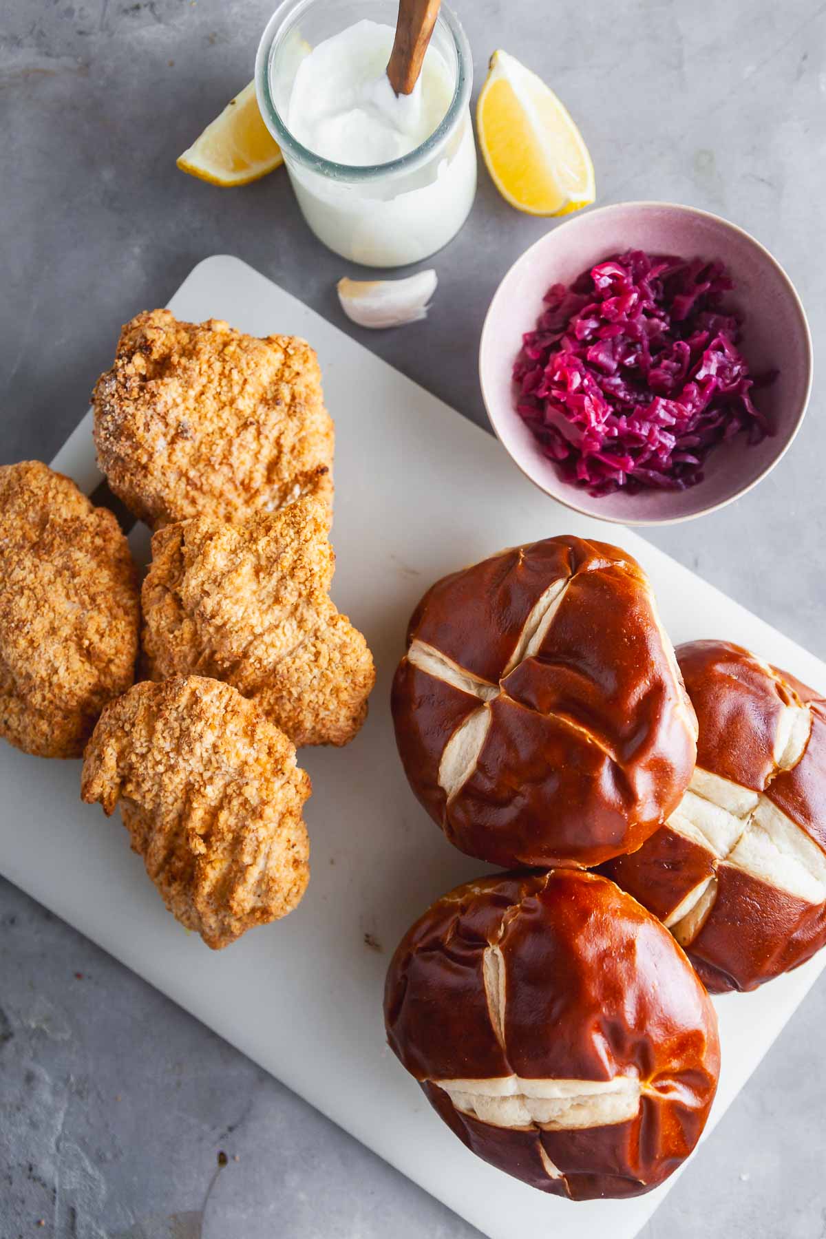 Ingredients for making chicken schnitzel sandwiches with frozen chicken breasts.