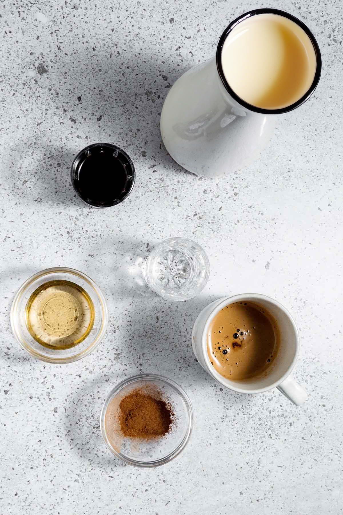 Flatlay image of ingredients needed to make an eggnog cocktail with espresso.