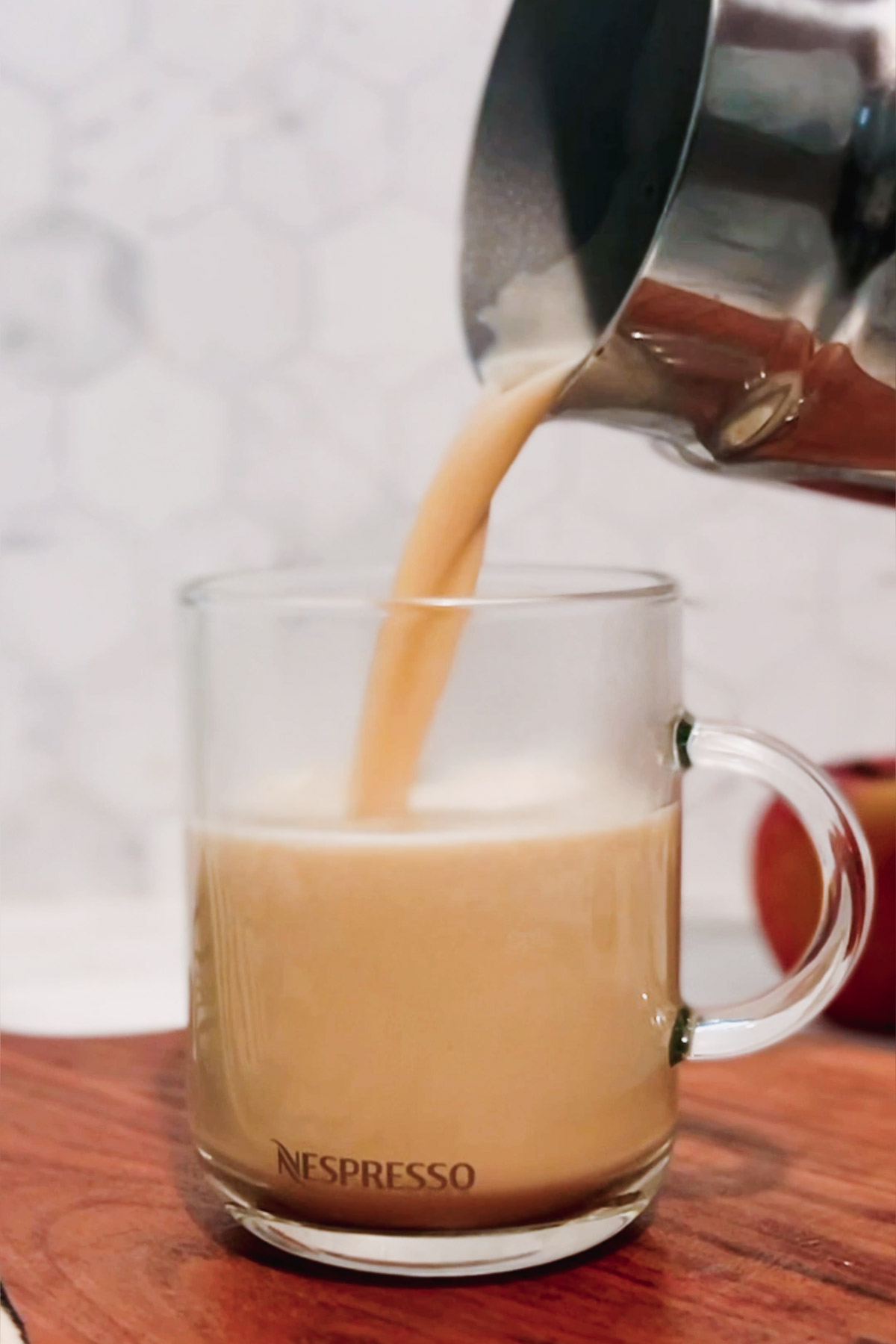 Pouring the milk into a mug. 