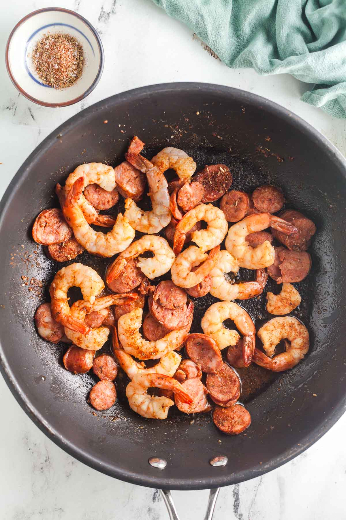 Saute the shrimp and sausage. 