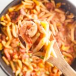 Closeup view of one pot jambalaya pasta on a spoon.