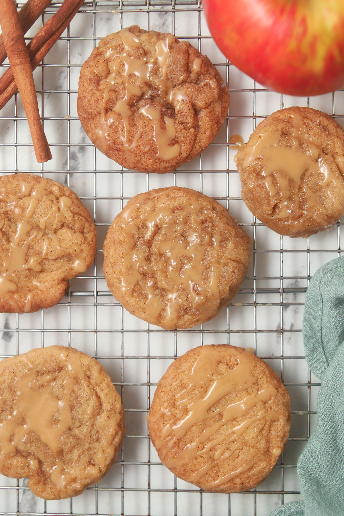 Chewy apple cider sugar cookies on a cooling rack.