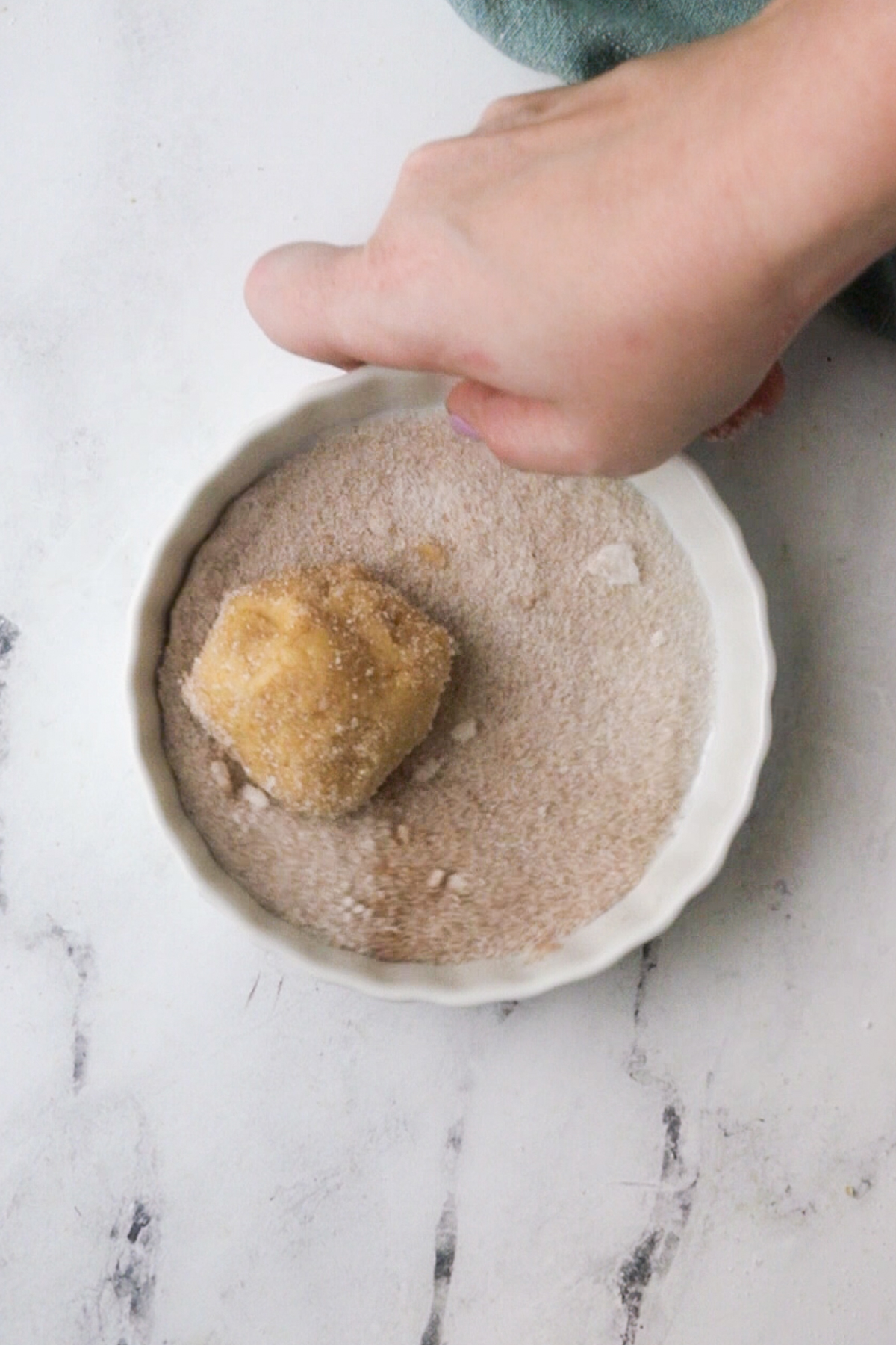 coat each ball of dough in cinnamon and sugar.