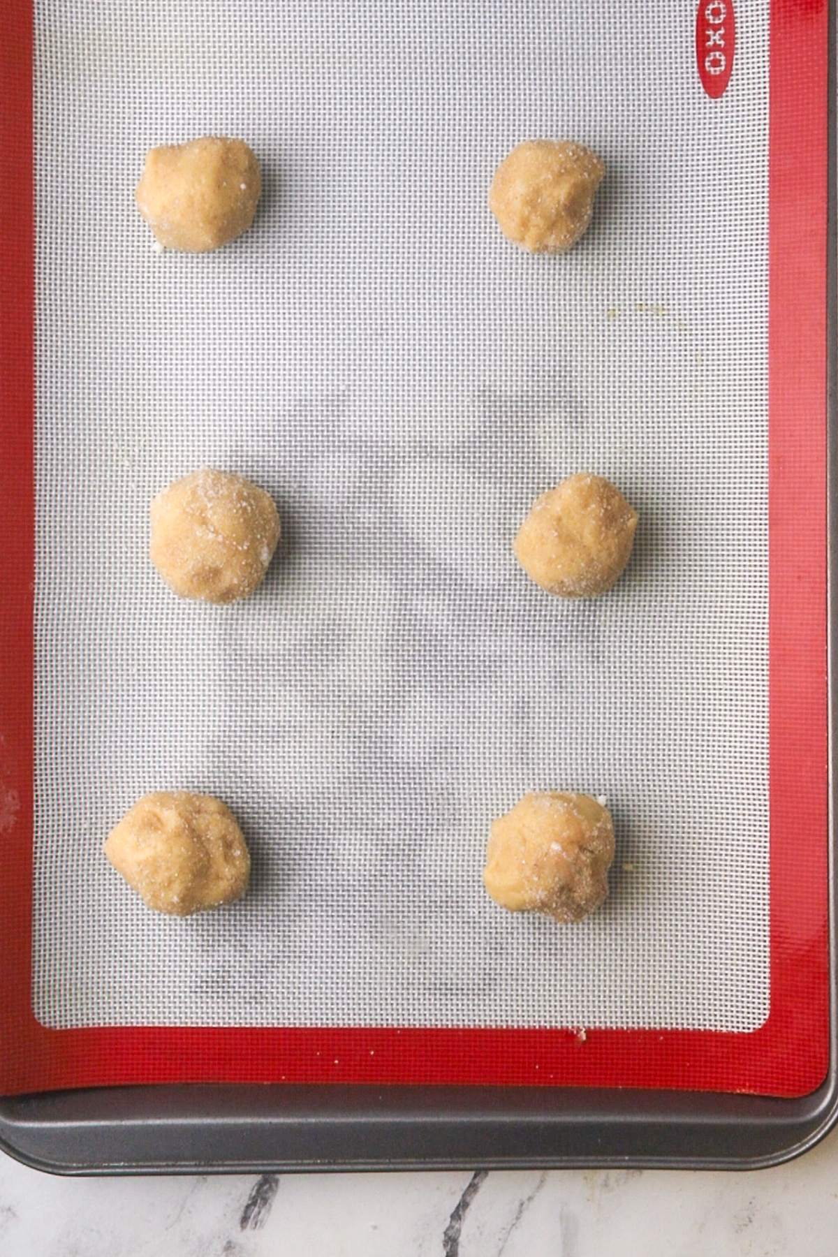 Raw cookie dough on a baking sheet.
