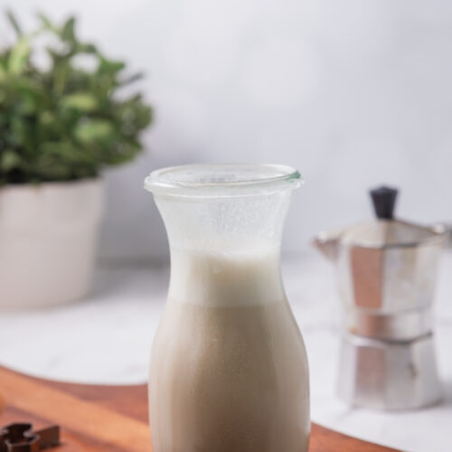A glass bottle of homemade coffee creamer.