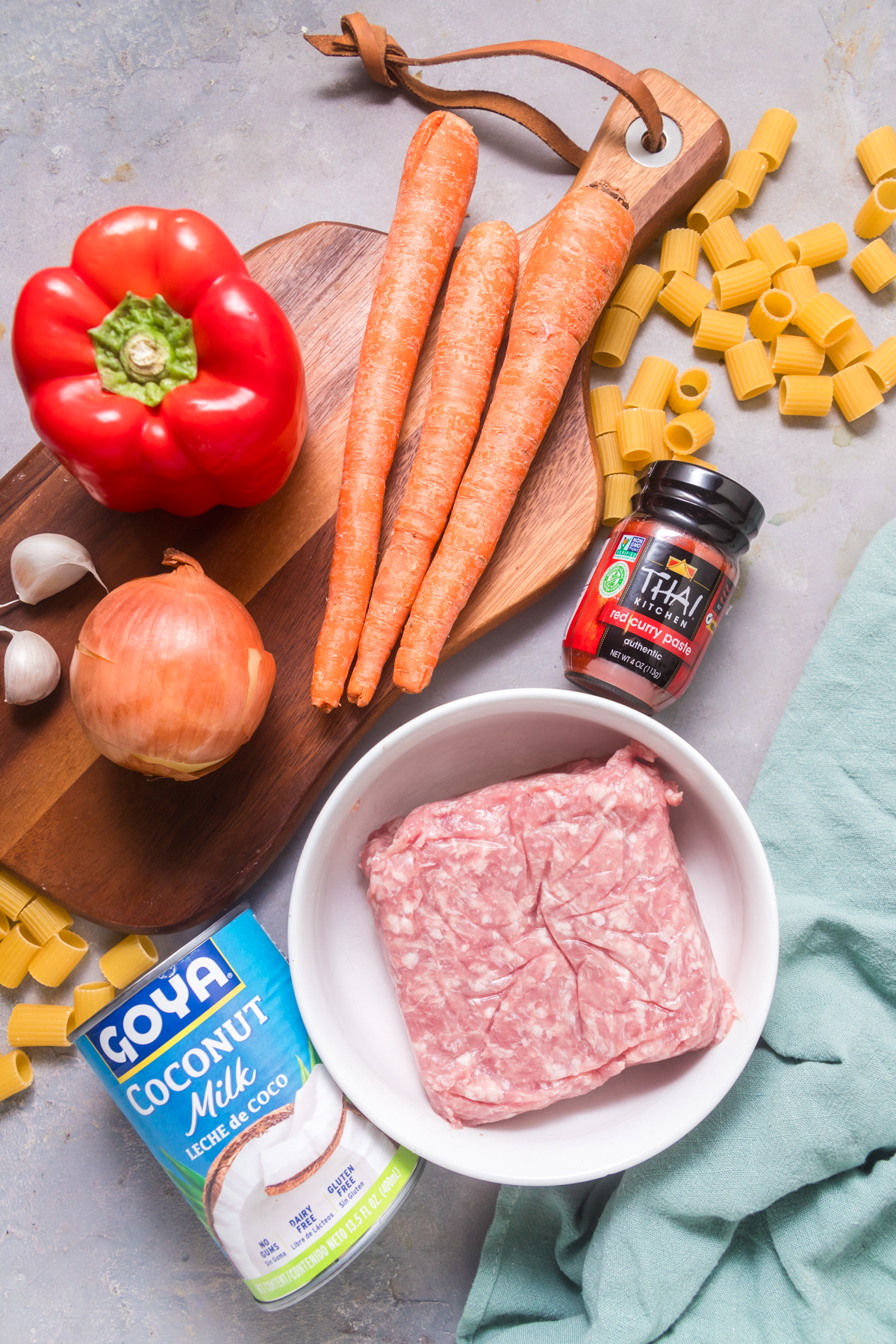 Ingredients for red curry pasta sauce, including carrots, red bell pepper, and coconut milk. 