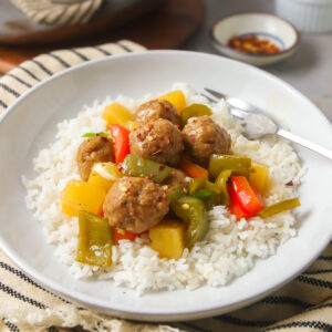 Sweet and Sour Meatballs with pineapple and peppers over rice.