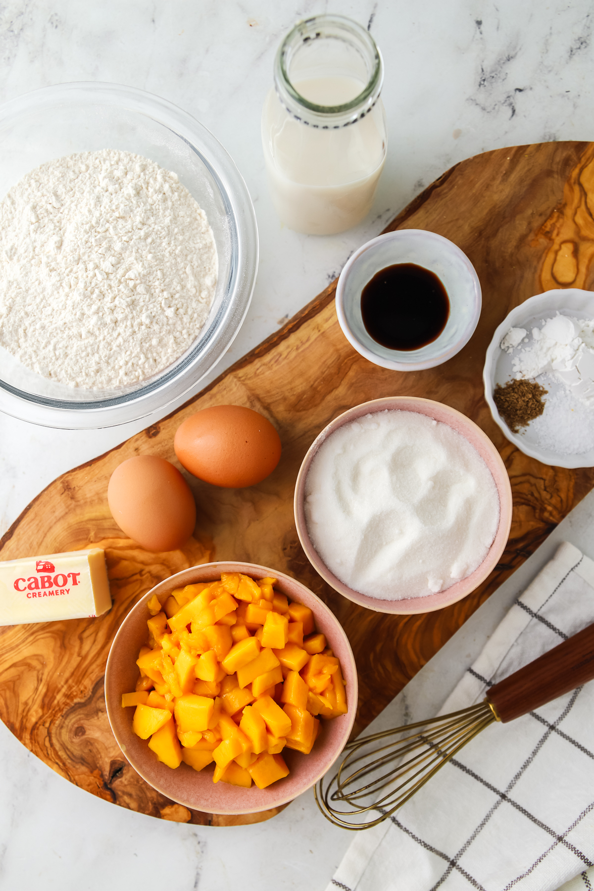 Mango bread ingredients on a wood serving board. 