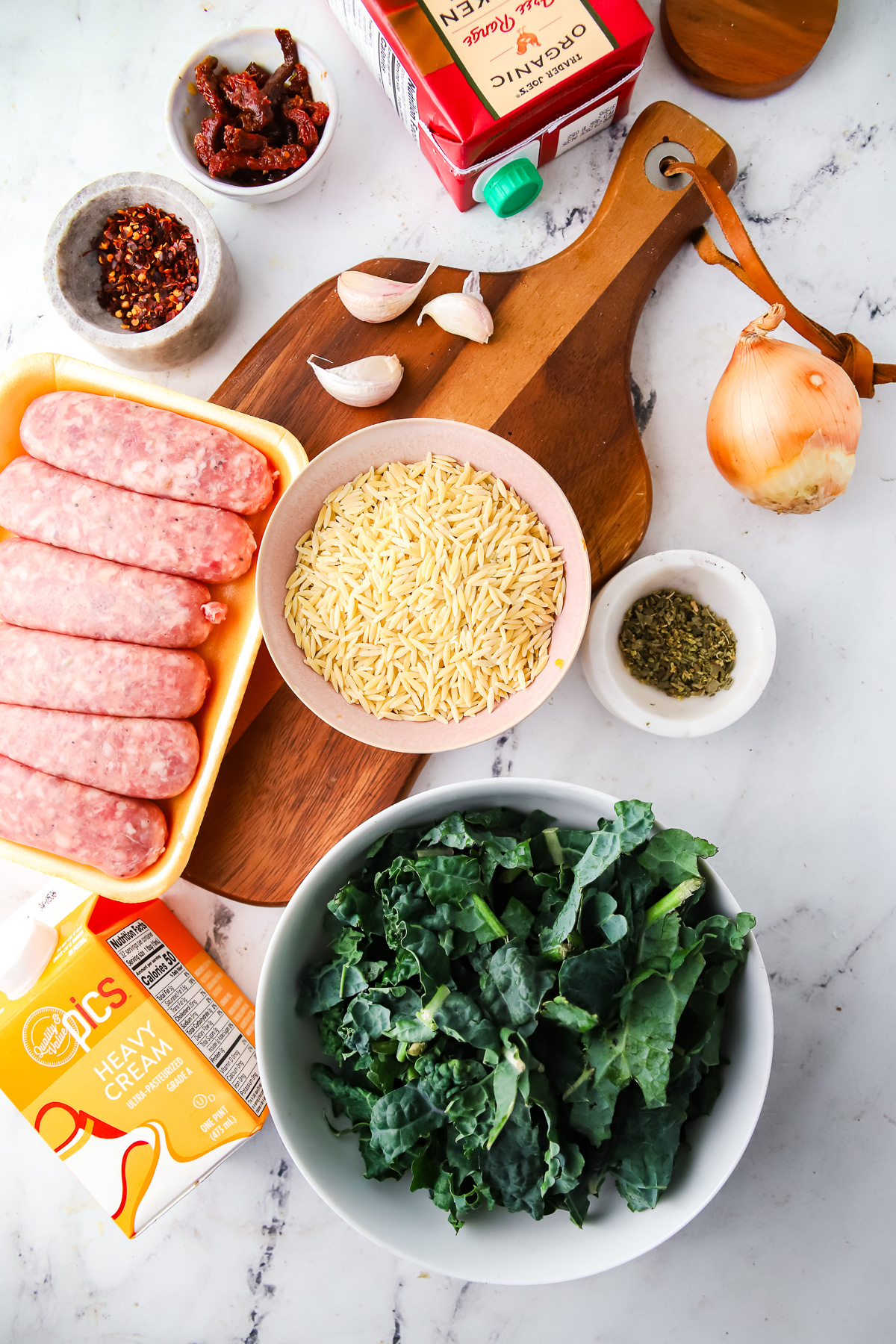 Ingredients needed to make one pot creamy tuscan orzo. 