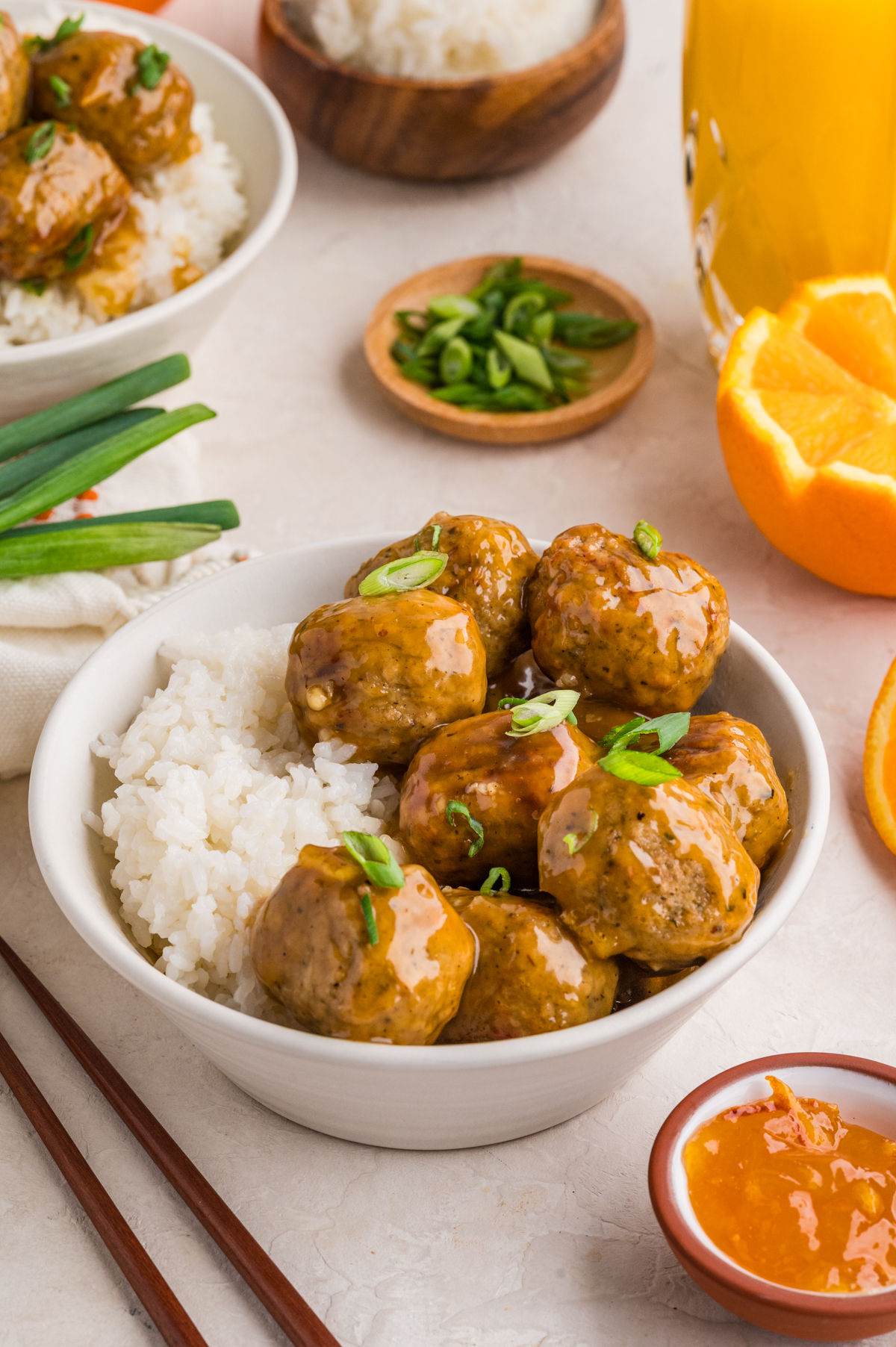 Orange glazed meatballs, inspired by Chinese takeout, over white rice.