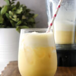 A glass of creamy passionfruit limeade over ice.