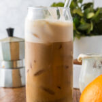 Orange cream cold brew coffee on a wooden cutting board.