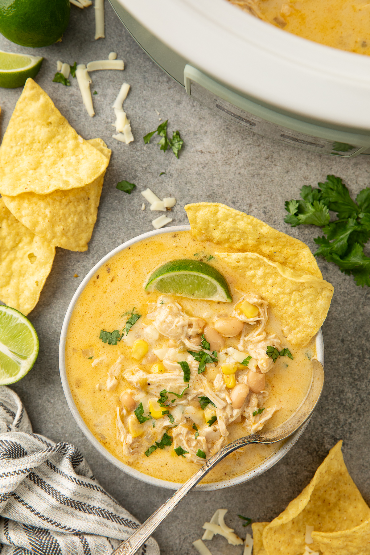 Crockpot white chicken chili with corn and queso.